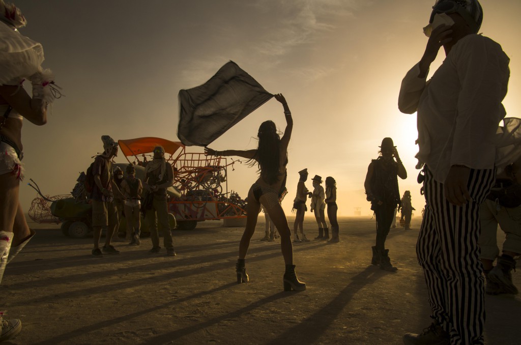 Sihouetted revellers at a Burning Man wedding, Black Rock, Nevada