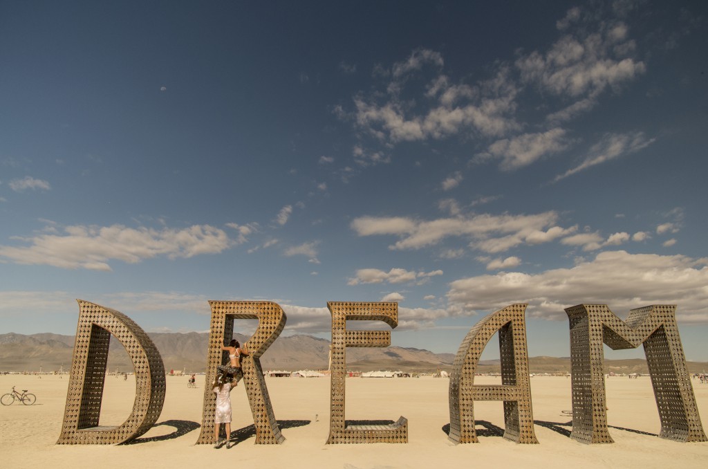 Two girls climb through Burning Man art, Black Rock, Nevada