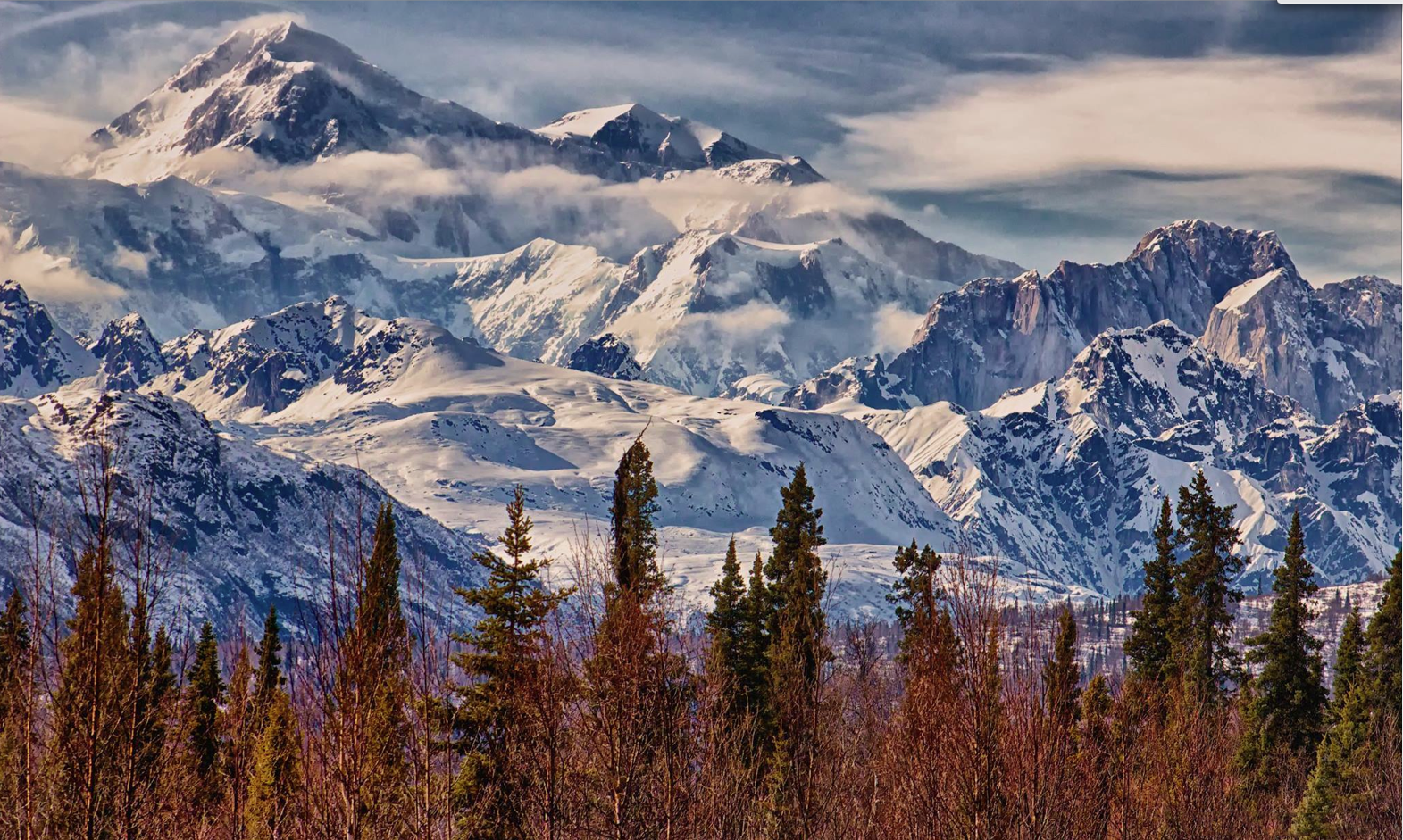 A view of Denali, the tallest mountain in North America and surrounding mountain range.