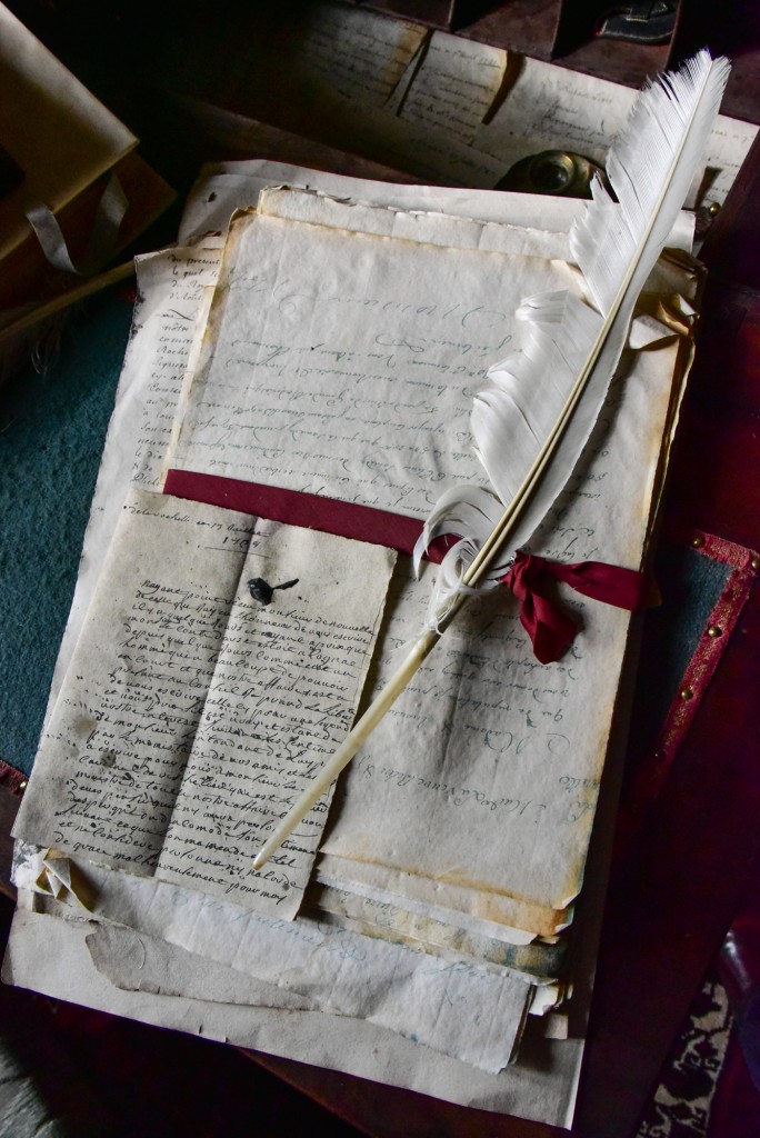 Jean Martell’s log books, invoices and letters tied with a red ribbon and a white quill on top, Cognac, France