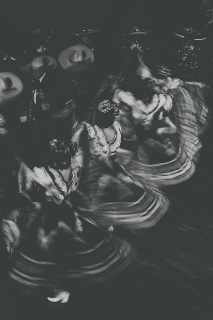 Whirling dancers with skirts flared out all in a row at Day of the Dead, Mexico