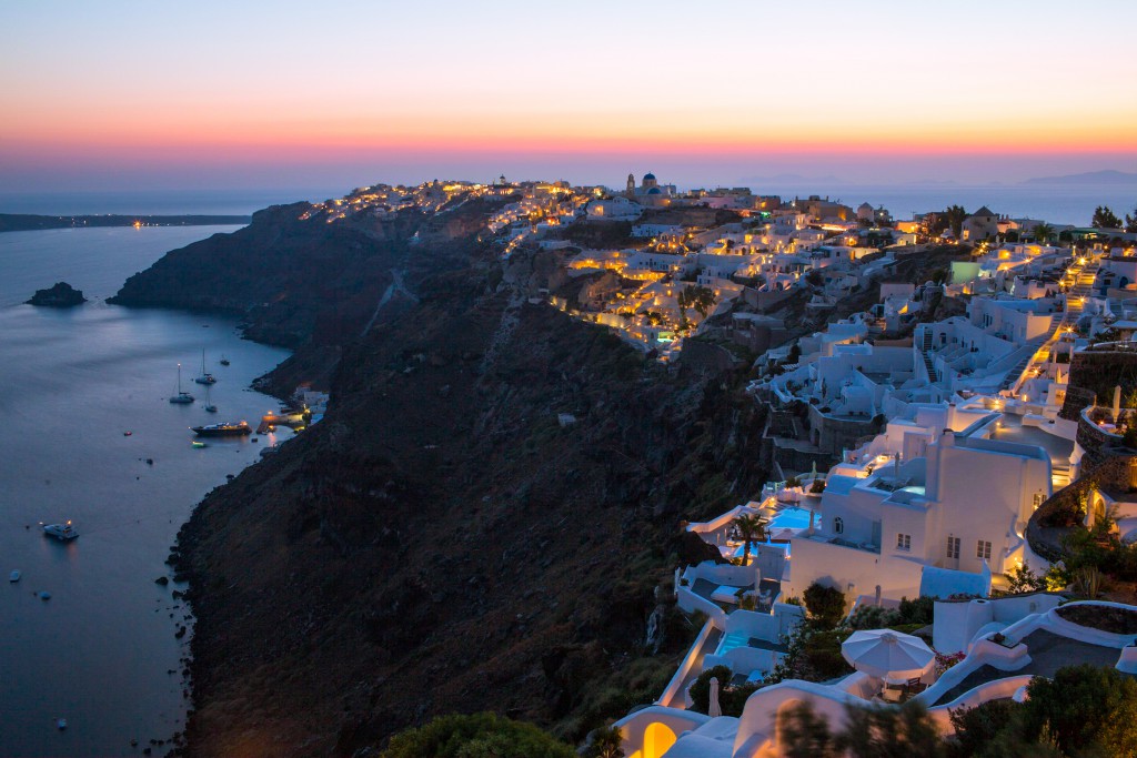 Iconic Santorini rests against the caldera at sunset.