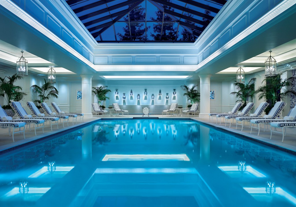 View of a blue pool with loungers around it and a glass roof California Health and Longevity Institute Wellness Retreat