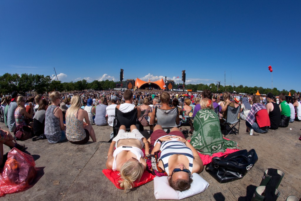 Two people lying down in the massive crowd