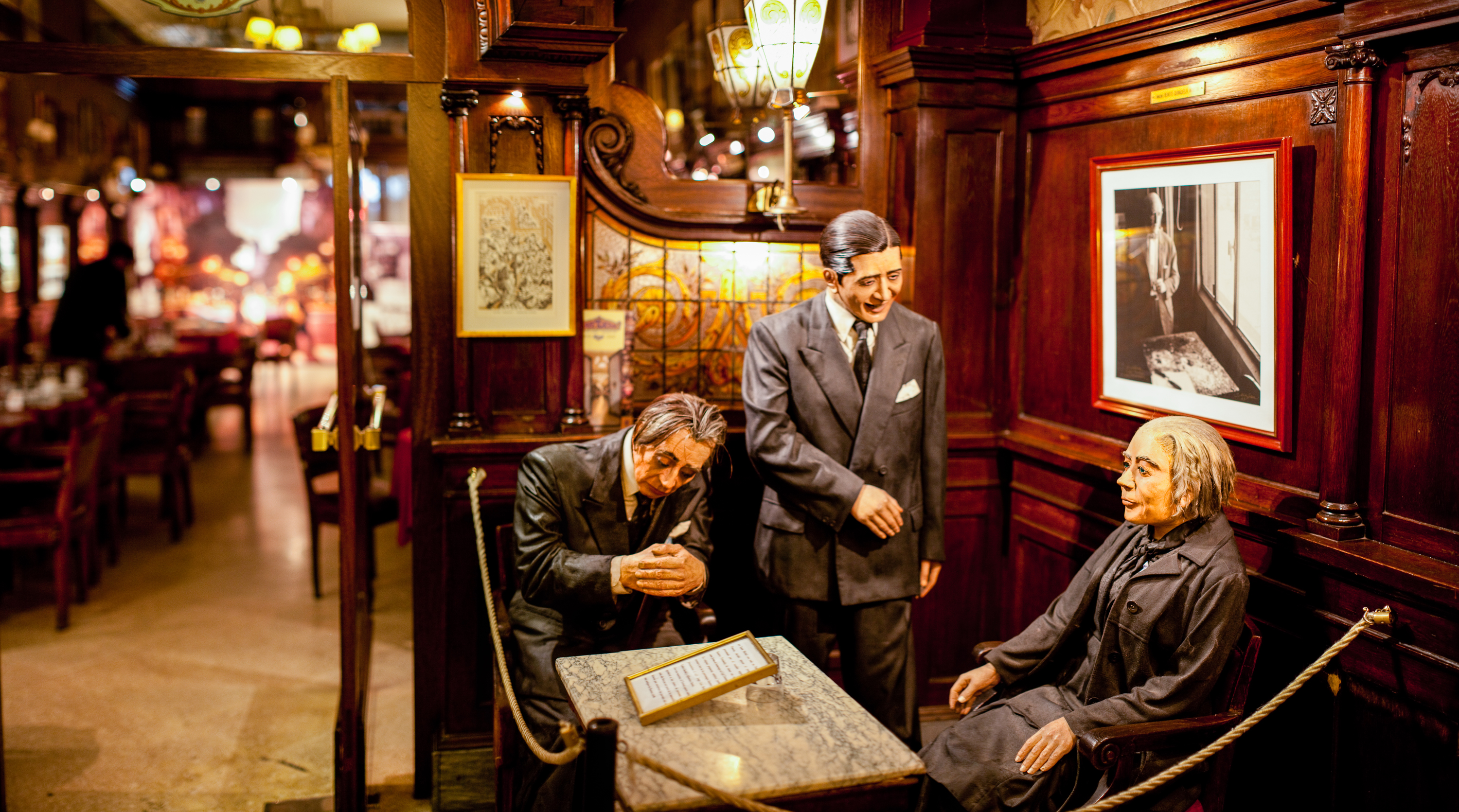 Three life sized wax figures of Borges, Gardel and Alfonsina Storni around a table in Cafe Tortoni