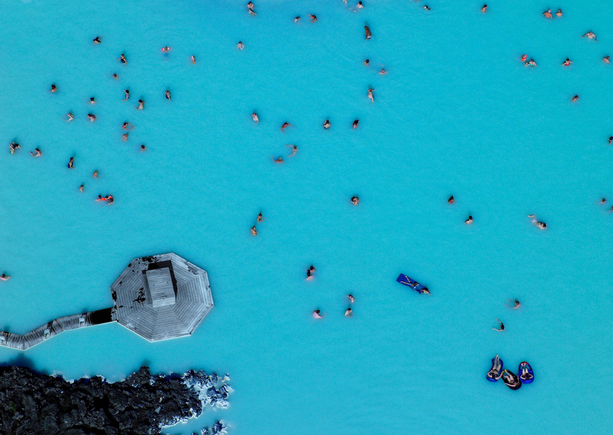 An aerial view of a very blue lagoon, an octagonal jetty showcasing the health spa culture in Norway