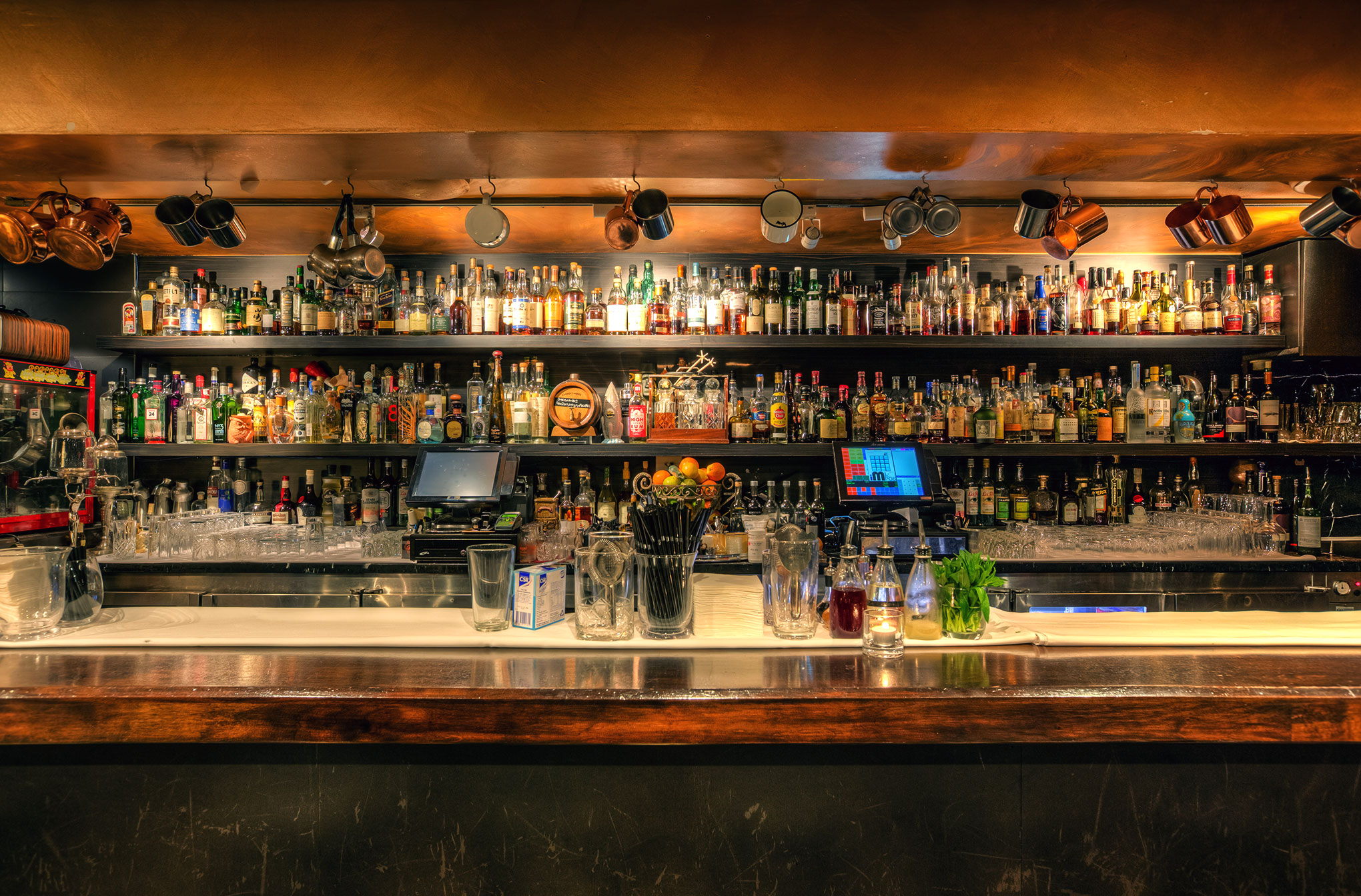 A view of the bar and shelves of alcohol bottles behind it at Eau de Vie on Darlinghurst Road in Kings Cross, Sydney.