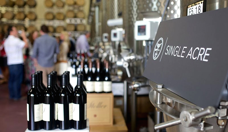 A counter full of wine bottles in the tasting room at Stoller Vineyards.