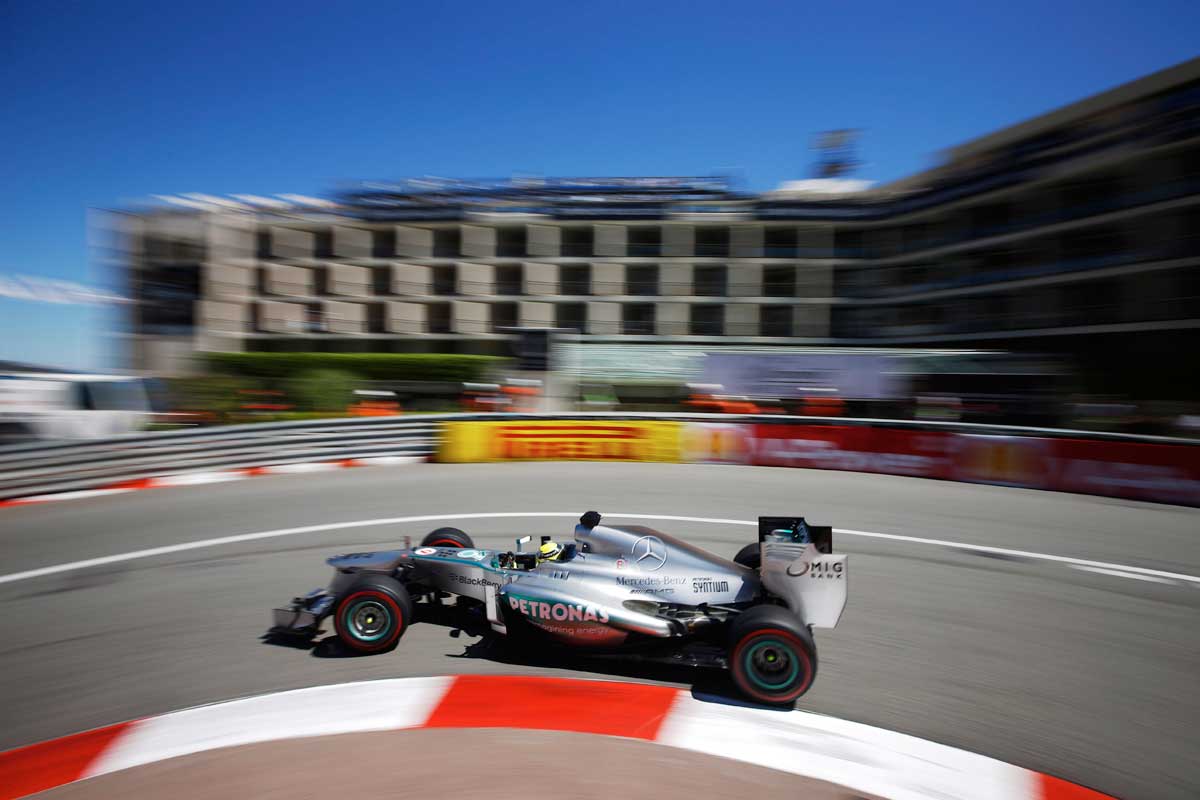 A timelapse image of a fast siver car going round a corner at the Grand Prix, Monaco