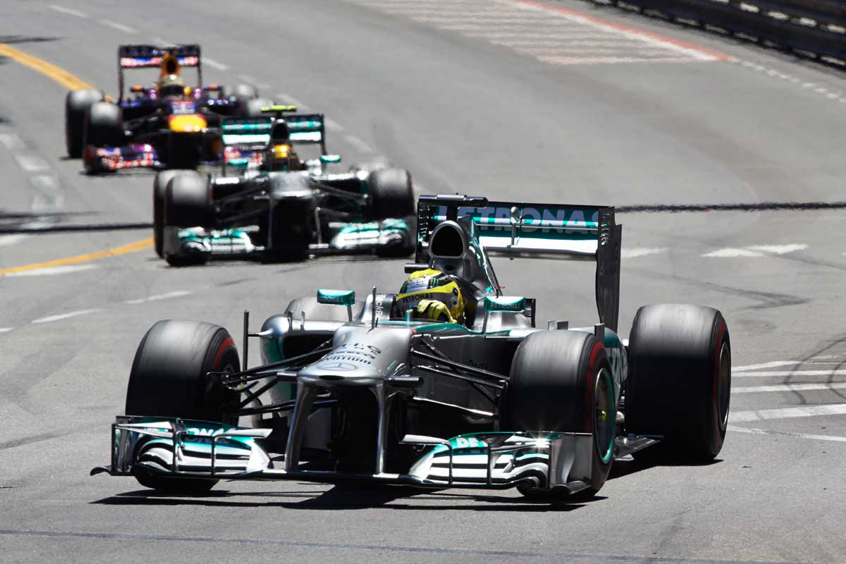 Three cars racing on the track at the Monaco F1 Grand Prix