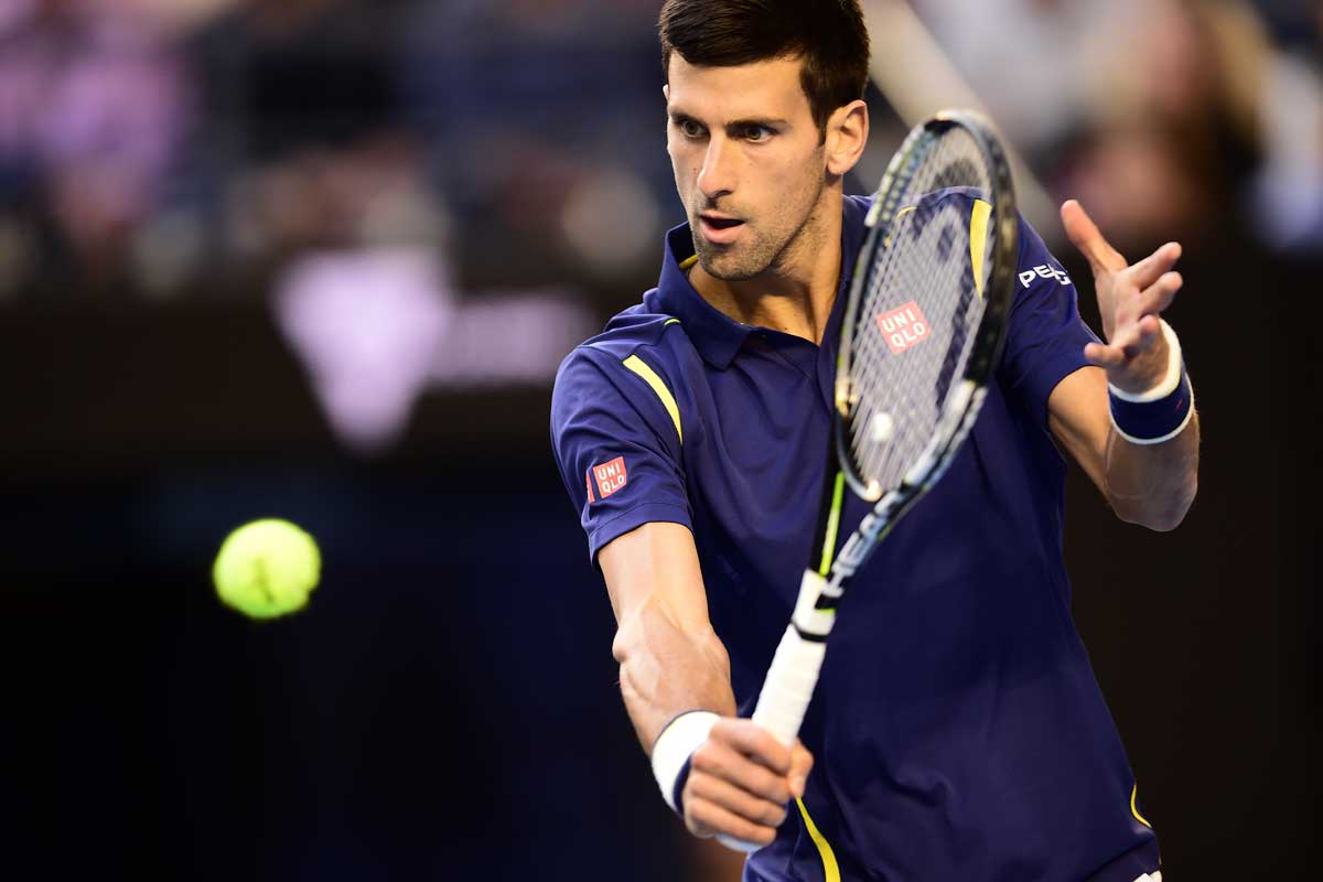 Close-up of Djokovic holding his racket about to hit a tennis ball in a right cross shot