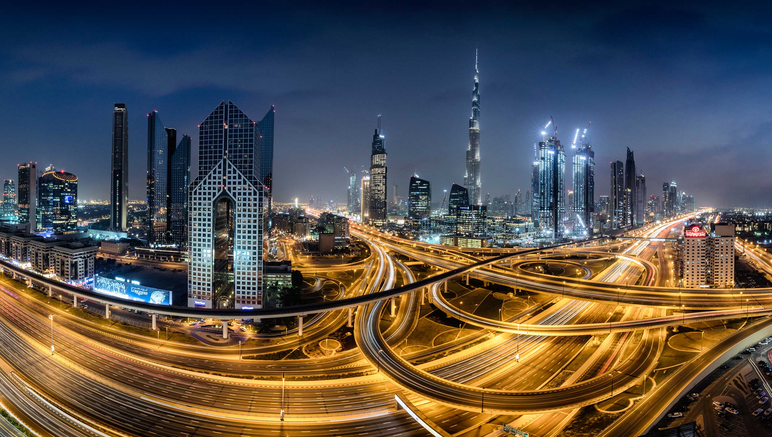 The skyscrapers, flyovers and highways of Dubai all lighted up at night