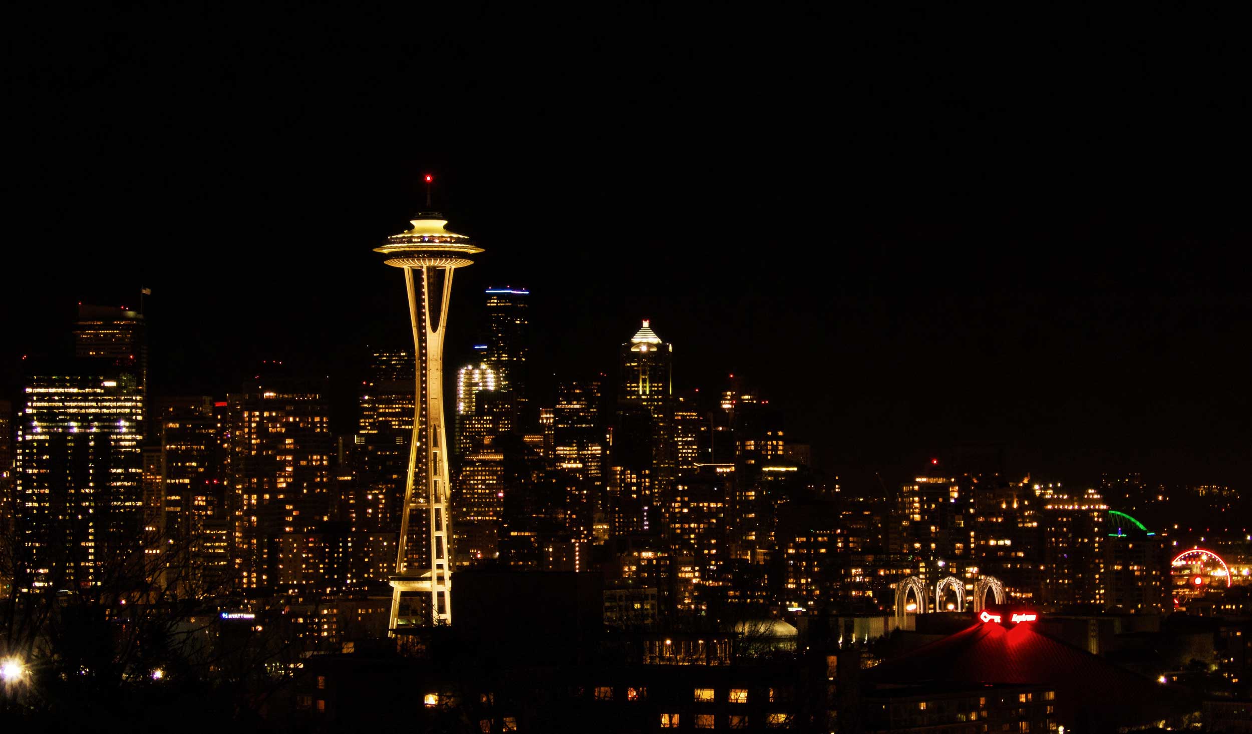 Lighted up tall, slim tower dominating a city skyline at night, Seattle, USA 