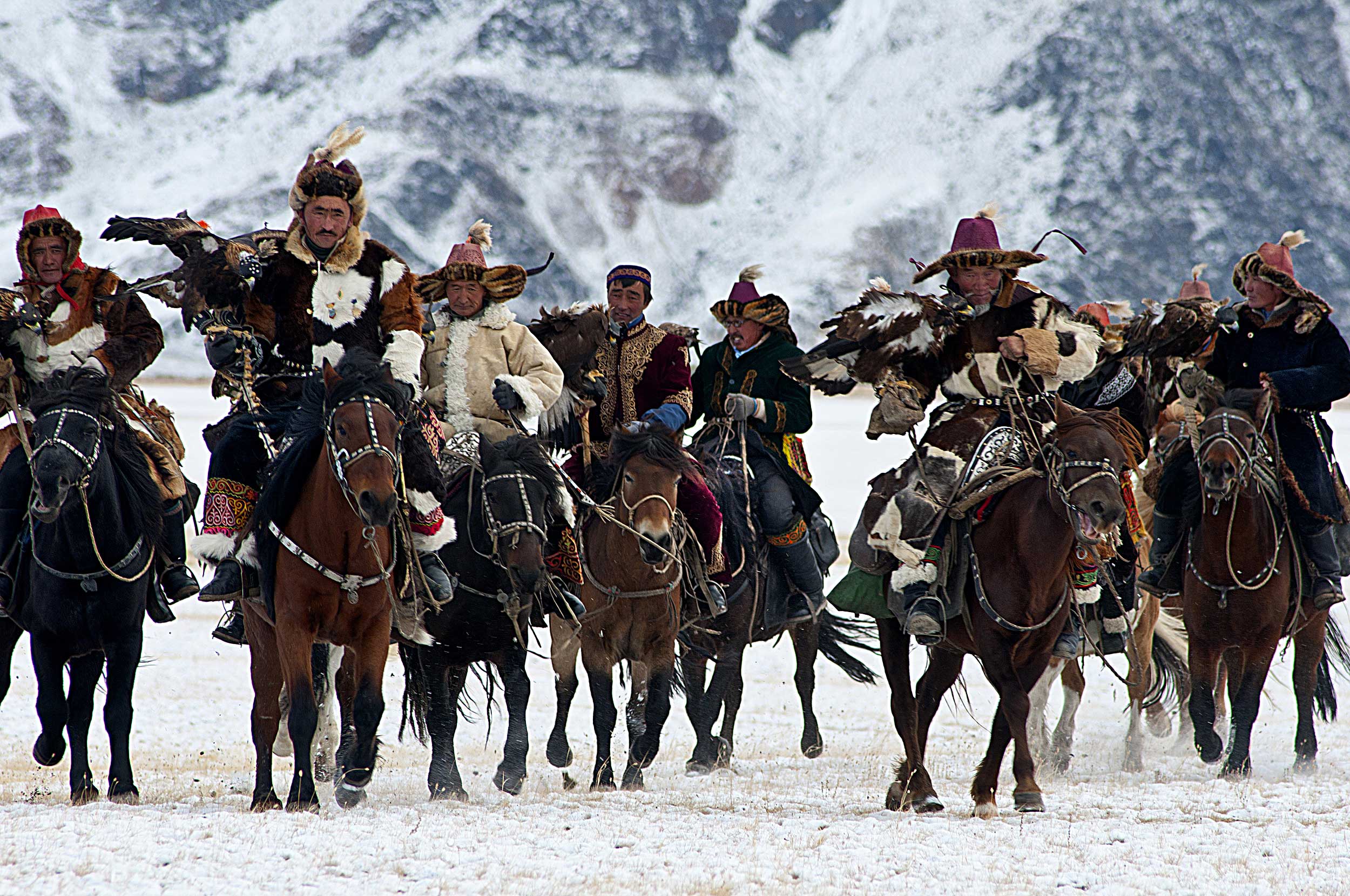 Group of Mongolian huntsmen on horses.