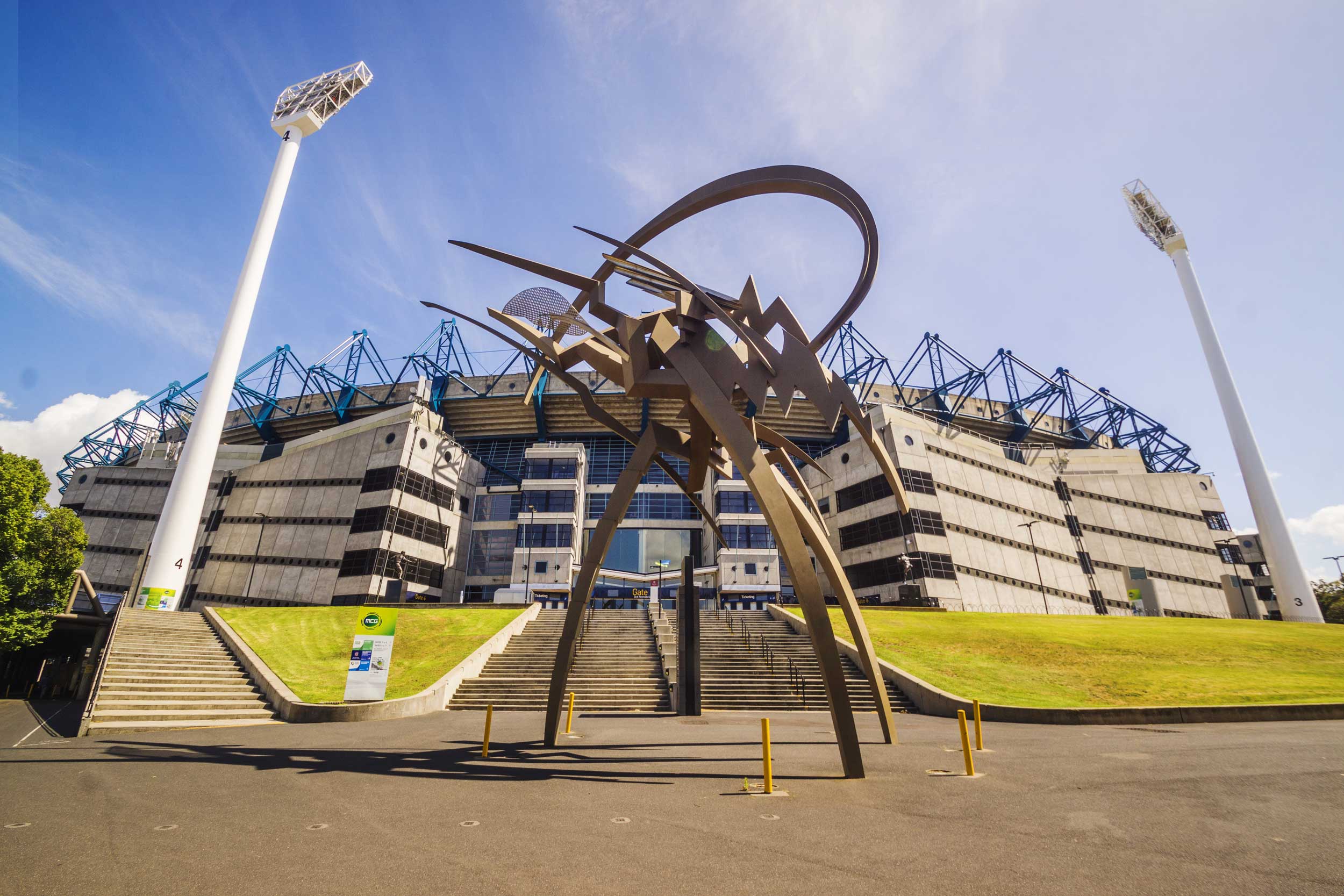 A large metal sculpture in front of a circular building, MCG, Melbourne