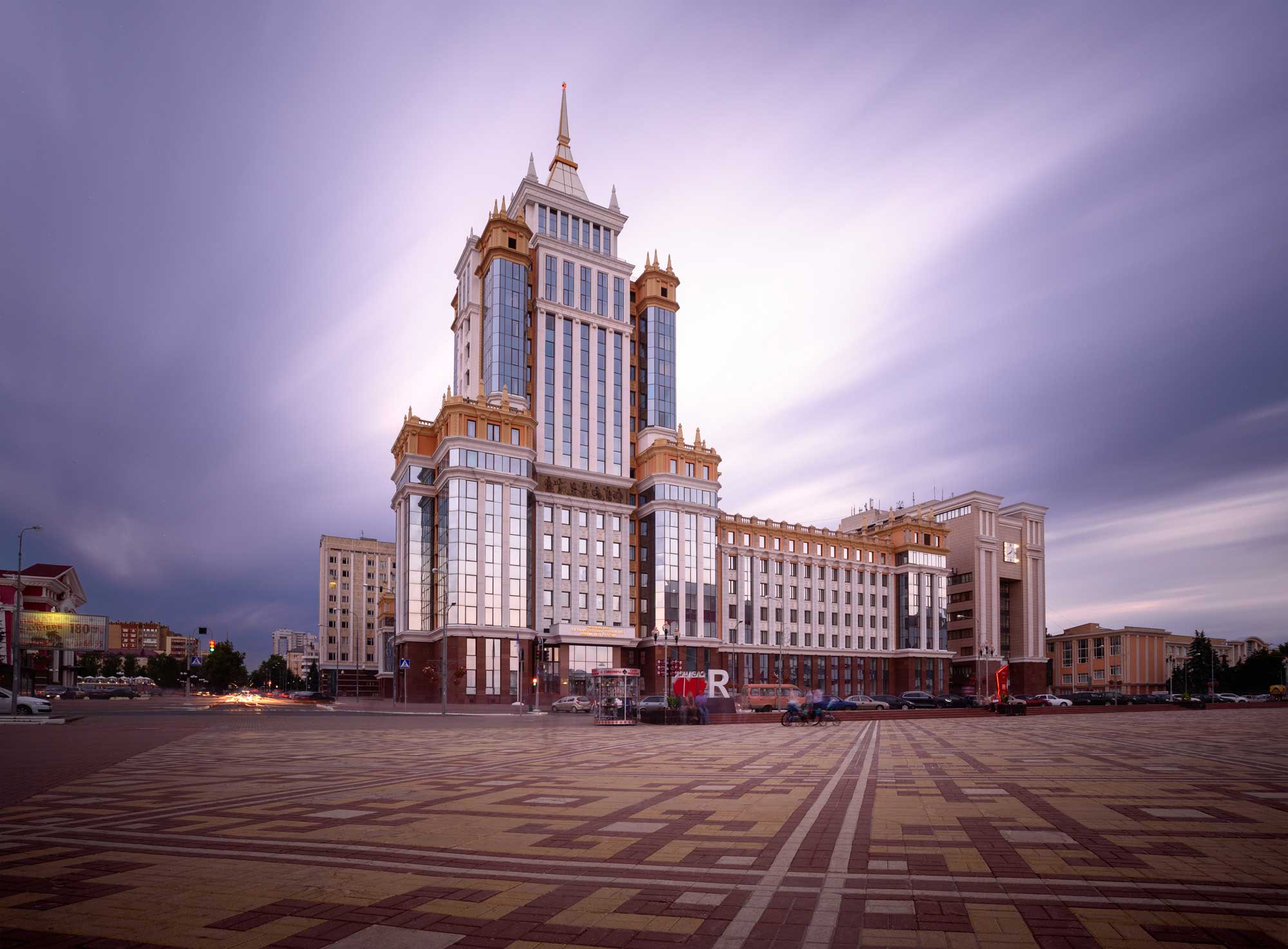 A large and imposing grey building backlit by the evening sky, Russia