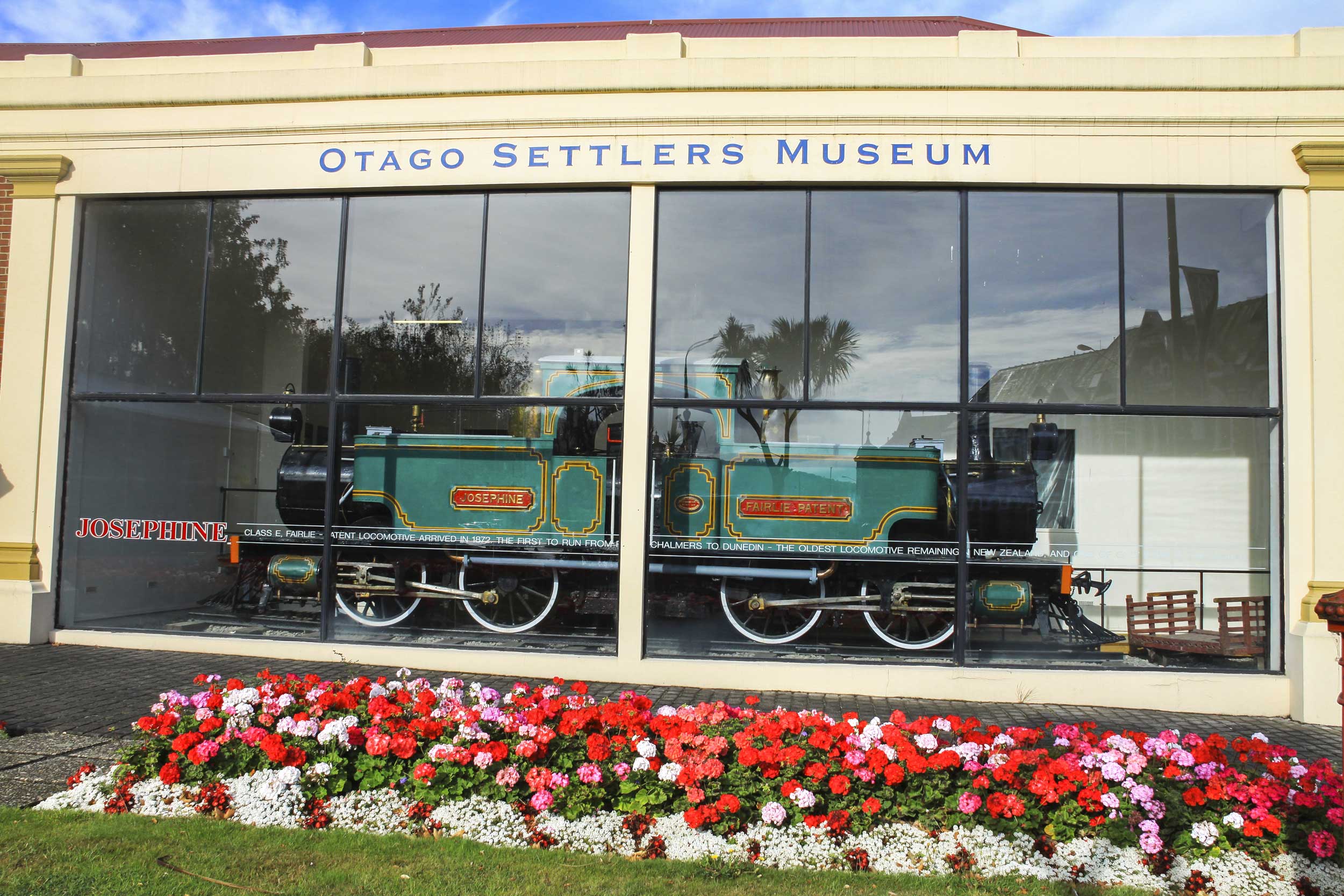 Old steam engine seen through a glass window, Dunedin, New Zealand